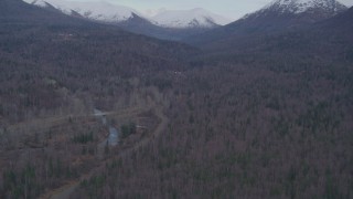 AK0001_0248 - 4K aerial stock footage fly over forested foothills, reveal Chugach Mountains, Fort Richardson, Anchorage