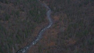 AK0001_0250 - 4K aerial stock footage river through forested foothills, Chugach Mountains, Fort Richardson, Anchorage