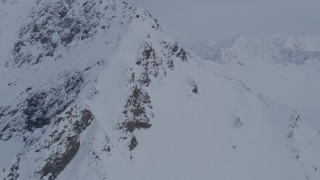 AK0001_0264 - 4K aerial stock footage approaching snowy peak, valley, Chugach Mountains, Alaska