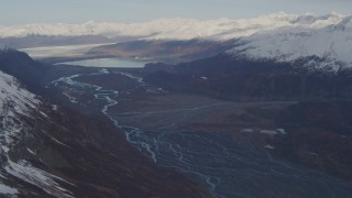 AK0001_0279 - 4K aerial stock footage flying over a river valley, pan right to reveal a glacier, Inner Lake George, Alaska