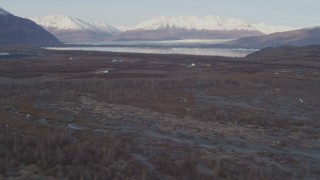AK0001_0281 - 4K aerial stock footage flying low over the river valley, approaching Inner Lake George, Alaska