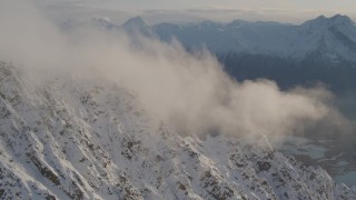 AK0001_0296 - 4K aerial stock footage snowy slopes, clouds, Knik River Valley, Knik Glacier, Chugach Mountains, Alaska