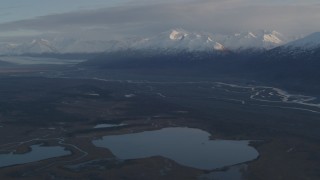 AK0001_0297 - 4K aerial stock footage flying by lakes and rivers, bordered by Chugach Mountains, Knik River Valley, Alaska