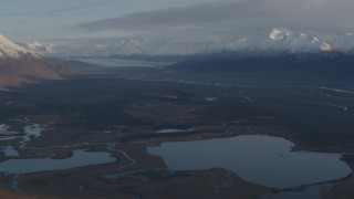 AK0001_0298 - 4K aerial stock footage flyby lakes and rivers, bordered by Chugach Mountains, Knik River Valley, Alaska