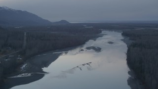AK0001_0305 - 4K aerial stock footage flying along the Knik River, tilt down, Knik River, Alaska, sunset
