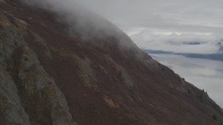 AK0001_0352 - 4K aerial stock footage slope of Chugach Mountains, reveal the Turnagain Arm of the Cook Inlet, Alaska