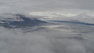 AK0001_0353 - 4K aerial stock footage flying through low clouds hovering over the Turnagain Arm of the Cook Inlet, Alaska