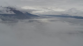 AK0001_0354 - 4K aerial stock footage descending through clouds, approach Turnagain Arm of the Cook Inlet, Alaska