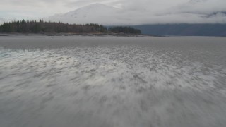 AK0001_0363 - 4K aerial stock footage fly low over water, rocky peninsula, Turnagain Arm of the Cook Inlet, Alaska