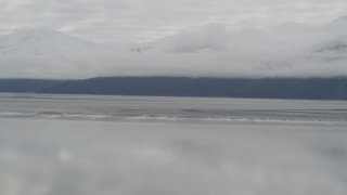 AK0001_0367 - 4K aerial stock footage flying by cloud covered Kenai Mountains, Turnagain Arm of the Cook Inlet, Alaska