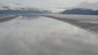 AK0001_0368 - 4K aerial stock footage descending toward the glassy water, Turnagain Arm of the Cook Inlet, Alaska