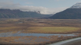 AK0001_0383 - 4K aerial stock footage approaching marshland and rivers, Chugach Mountains, Portage, Alaska