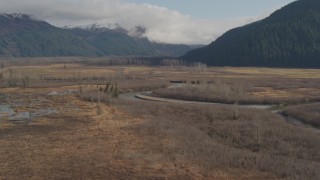 AK0001_0384 - 4K aerial stock footage flying over rivers, marshland, approaching train tracks, Portage, Alaska