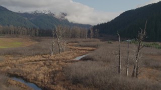 AK0001_0385 - 4K aerial stock footage train tracks, Chugach Mountains, revealing rivers, homes, Portage, Alaska