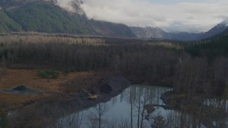 AK0001_0386 - 4K aerial stock footage flying low over trees and rivers, revealing small homes, Portage, Alaska