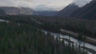 AK0001_0388 - 4K aerial stock footage flying low over forest, revealing river, Portage Glacier Road, Portage Lake, Alaska