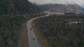 AK0001_0389 - 4K aerial stock footage truck on Portage Glacier Highway, tunnel through mountain, Portage Lake, Alaska