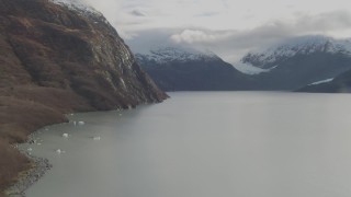 AK0001_0391 - 4K aerial stock footage flying over lake, approaching shoreline, Portage Lake, Alaska