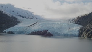 AK0001_0393 - 4K aerial stock footage flying by glacier, on the shore of Portage Lake, Portage Glacier, Alaska