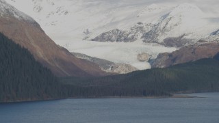 AK0001_0398 - 4K aerial stock footage fly by glacier near shore, snowy Chugach Mountain peaks, Passage Canal, Alaska