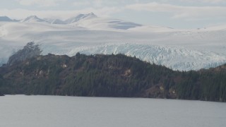 AK0001_0469 - 4K aerial stock footage flying by an island in the bay, glacier behind it, Blackstone Bay, Alaska