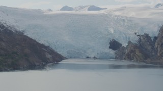 AK0001_0471 - 4K aerial stock footage flying by glacier spilling into Blackstone Bay, Alaska