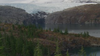 AK0001_0477 - 4K aerial stock footage flying over edge of island, pan to reveal glacier, Blackstone Bay, Alaska