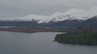 AK0001_0483 - 4K aerial stock footage flying by island, snow capped Chugach Mountains, Blackstone Bay, Alaska