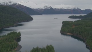 AK0001_0494 - 4K aerial stock footage flying over shore, approaching barge, Passage Canal, Shotgun Cove, Alaska
