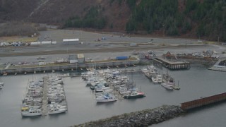 AK0001_0501 - 4K aerial stock footage flying by docked boats and ships, Whittier, Alaska