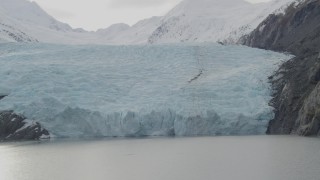 AK0001_0505 - 4K aerial stock footage flying by the edge of glacier on Portage Lake, Portage Glacier, Alaska