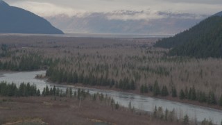 AK0001_0509 - 4K aerial stock footage flying by the river valley, tilt down to the river, Portage, Alaska