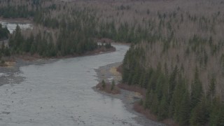 AK0001_0510 - 4K aerial stock footage approaching a river cutting through forest, Portage, Alaska