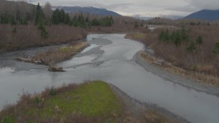 AK0001_0513 - 4K aerial stock footage flying along rivers cutting through forest in the valley, Portage, Alaska