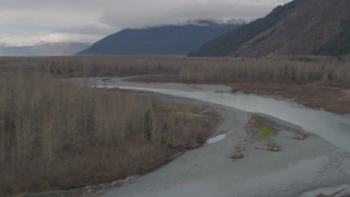 AK0001_0516 - 4K aerial stock footage following river cutting through dead trees in the valley, Portage, Alaska