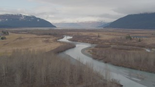 AK0001_0518 - 4K aerial stock footage flying low over river, ascending the tree line to reveal river valley, Portage, Alaska