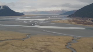 AK0001_0520 - 4K aerial stock footage flying by valley on the edge of Turnagain Arm of the Cook Inlet, Portage, Alaska