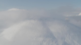 AK0001_0533 - 4K aerial stock footage flying by low clouds on the summit, Kenai Mountains, Alaska