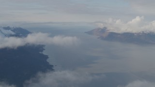 AK0001_0548 - 4K aerial stock footage fly by mountains, low clouds over the Turnagain Arm of the Cook Inlet, Alaska
