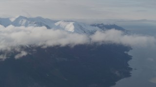 AK0001_0549 - 4K aerial stock footage fly by low clouds, Turnagain Arm of the Cook Inlet, and Kenai Mountains, Alaska