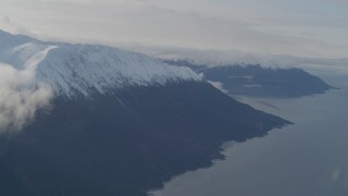 AK0001_0551 - 4K aerial stock footage fly over Turnagain Arm of the Cook Inlet, snow capped Kenai Mountains, Alaska
