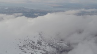 AK0001_0572 - 4K stock footage aerial video approach snowy peak, Downtown Anchorage, Chugach Mountains, Alaska