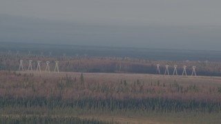 AK0001_0594 - 4K aerial stock footage flying by power lines, forests, Point MacKenzie, Alaska