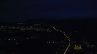 AK0001_0601 - 4K aerial stock footage following Glenn Highway, approach Chugach Mountains, Anchorage, Alaska, night