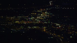 AK0001_0604 - 4K aerial stock footage flying by blurred lights, clearing to reveal city, city roads, Anchorage, Alaska, night