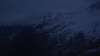 AK0001_0613 - 4K aerial stock footage flying by snowy Chugach Mountains, reveal river valley, Palmer, Alaska, sunrise