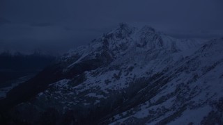 AK0001_0614 - 4K aerial stock footage flying by snowy Chugach Mountains, pan to river valley, Palmer, Alaska, sunrise