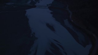 AK0001_0617 - 4K aerial stock footage flying over Knik River, reveal Old Glenn Highway Bridge, Knik River, Alaska, sunrise