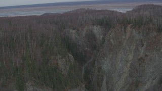 AK0001_0627 - 4K aerial stock footage flying over deep river gorge, forests, approaching river valley, Birchwood, Alaska