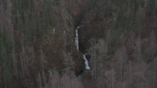 AK0001_0631 - 4K aerial stock footage approaching waterfall between wooded hills, Birchwood, Alaska